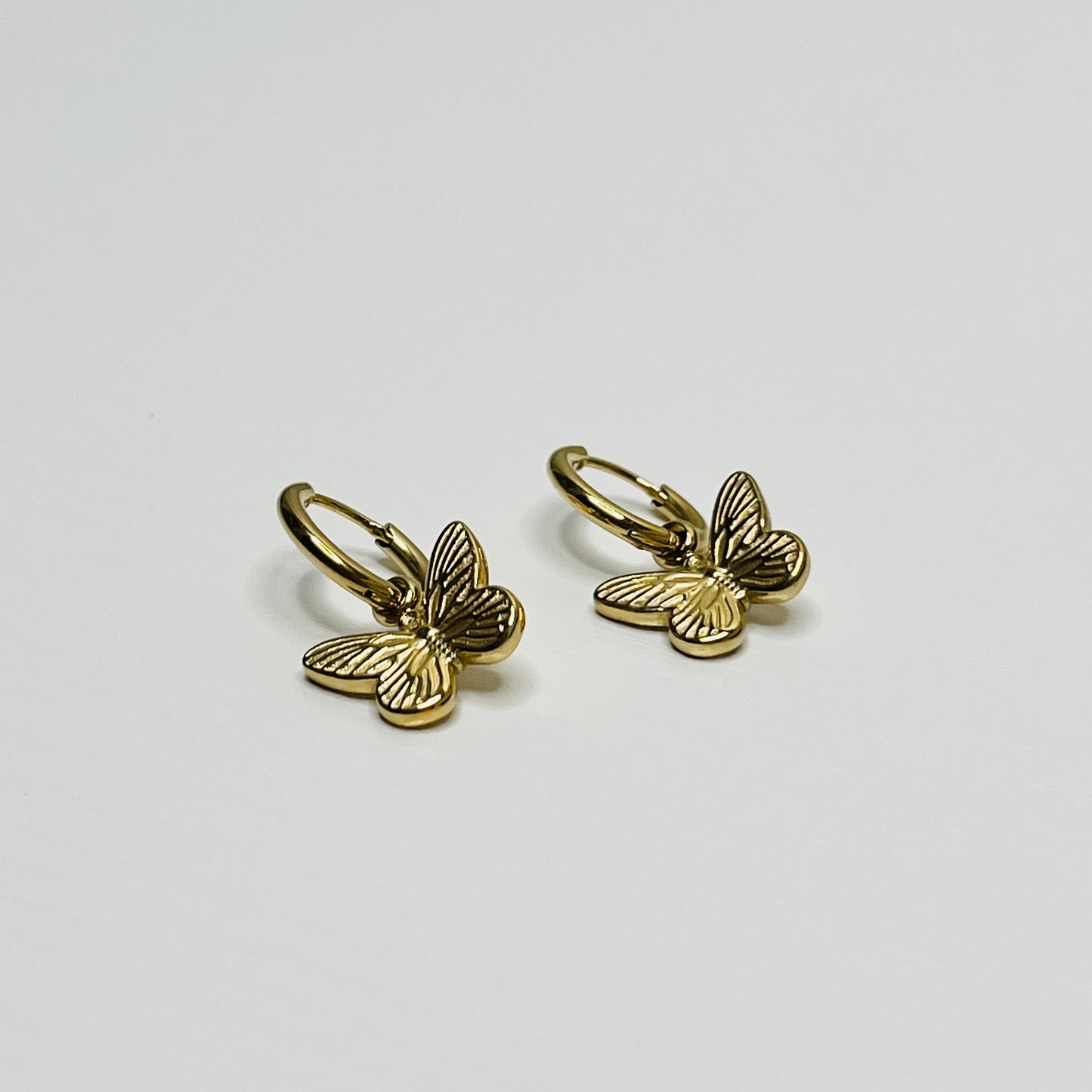 Gold butterfly hoop earring